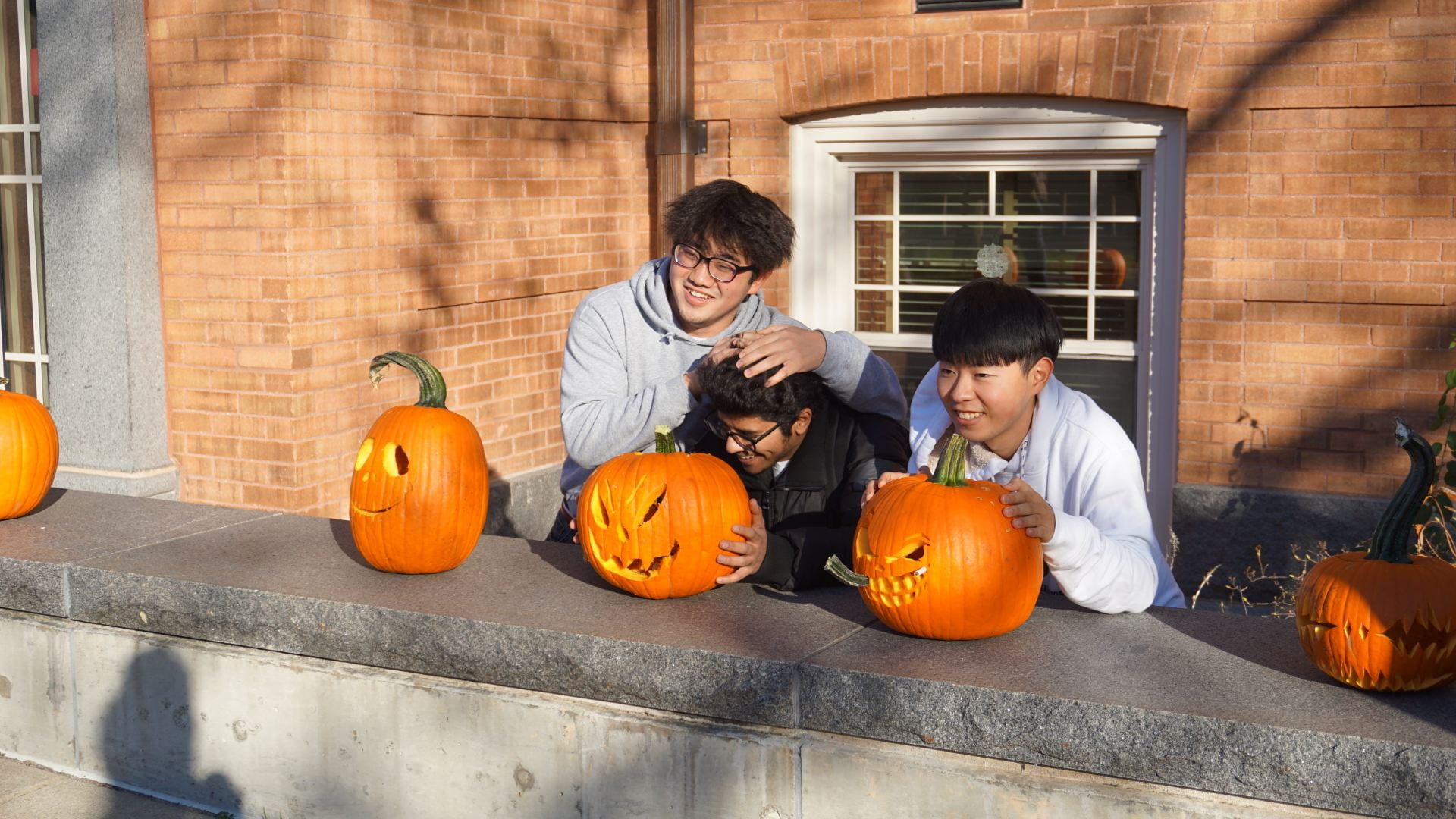 Students by their pumpkins