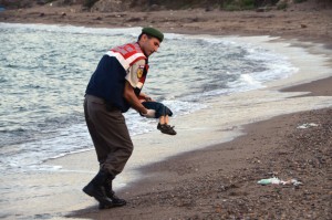 A paramilitary police officer carries the lifeless body of Alan Kurdi, 3, after a number of migrants died and a smaller number were reported missing after boats carrying them to the Greek island of Kos capsized.