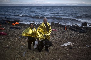 In this photo taken on Friday, Oct. 2, 2015, Syrian refugee Ali Shaheen, 62, and his wife Abeer, 52, who came from the countryside of Damascus, Syria, pose for a picture shortly after arriving on a dinghy from the Turkish coast to the northeastern Greek island of Lesbos. Me and my wife are old and we cant walk, we were mistreated in Turkey, we are so tired," Ali said. (AP Photo/Muhammed Muheisen)