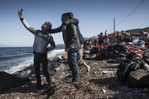 Refugees from Afghanistan and Syria take selfies after arriving in boats on the shores of Lesbos on November 2, 2015 near Molyvos, Greece. Lesbos, the Greek vacation island in the Aegean Sea between Turkey and Greece, faces massive refugee flows from the Middle East countries. (Photo by Etienne De Malglaive/Getty Images)