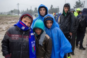 Migrants, who have just arrived by bus, queue in the rain at a refugee transit camp that has been set up on the border of Greece with the Former Yugoslav Republic of Macedonia on October 22, 2015 in Idomeni, Greece. Despite the worsening weather, thousands of migrants have continued to arrive at the small border village as they persist in their journey on towards Western Europe.  (Photo by Matt Cardy/Getty Images)